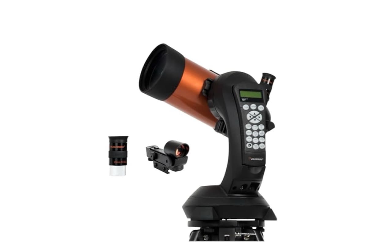 Celestron NexStar 4SE telescope on tripod against starry sky background